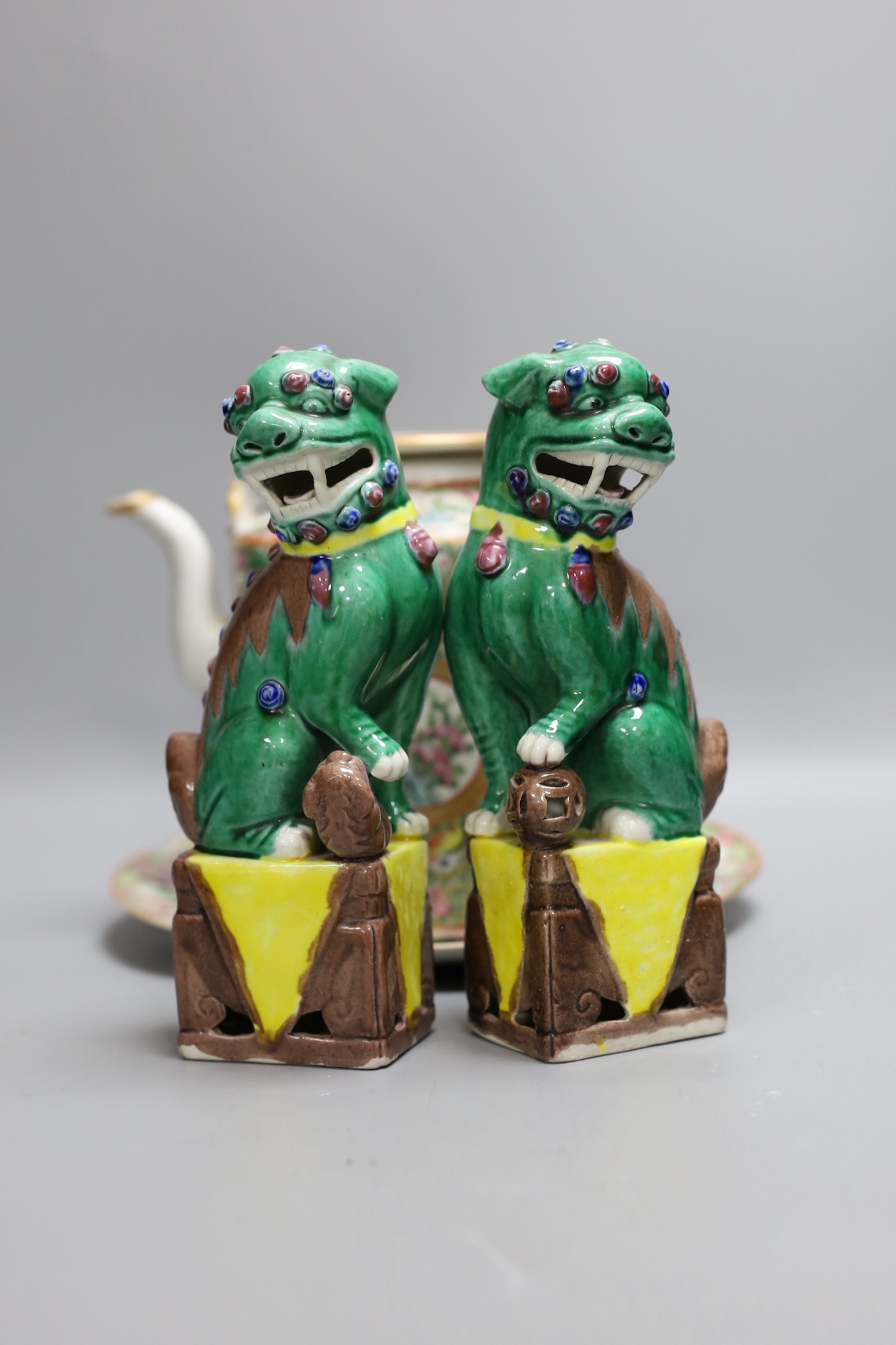 A Cantonese famille rose plate and teapot with cover, a pair of Chinese seated dogs, and a tureen with cover and oval dish, And a Chinese faux lacquer dragon and Phoenix dish, teapot 18 cms high
